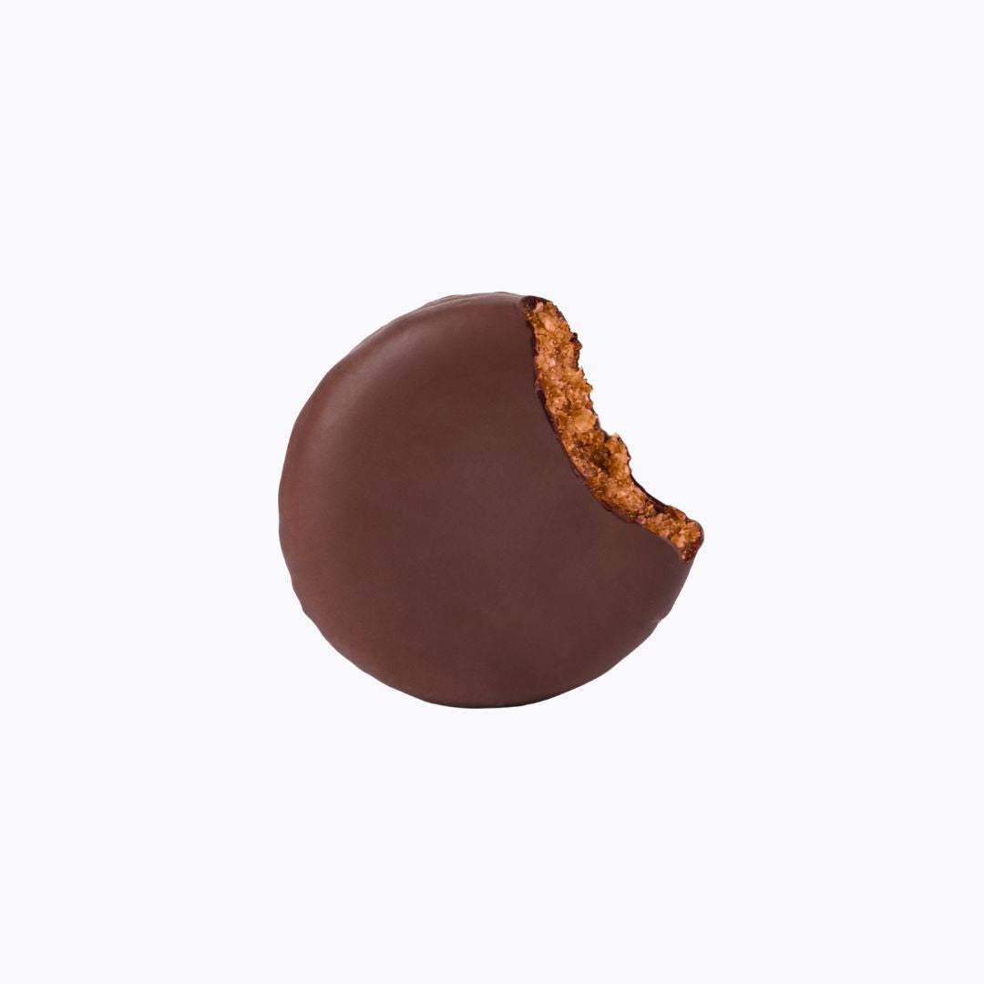 Chocolate-covered cookie with a bite taken out on a white background