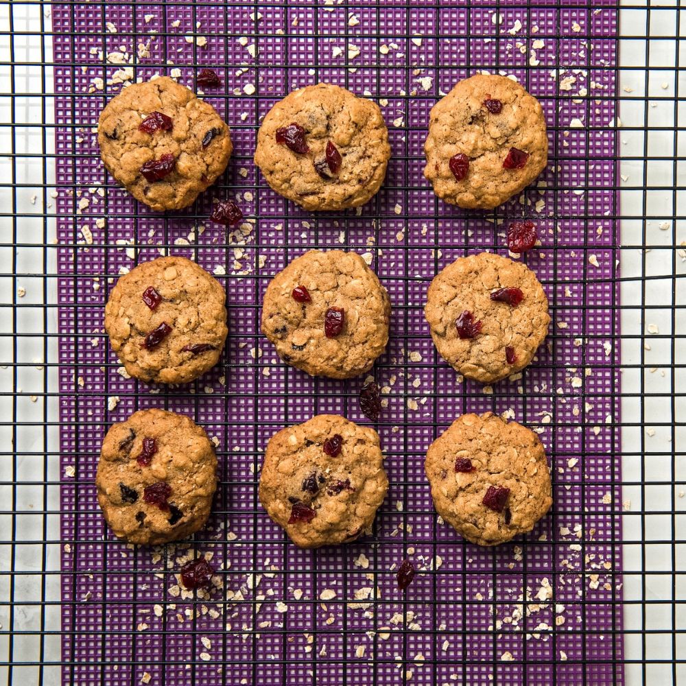Cookies with raisins on a purple cooling rack