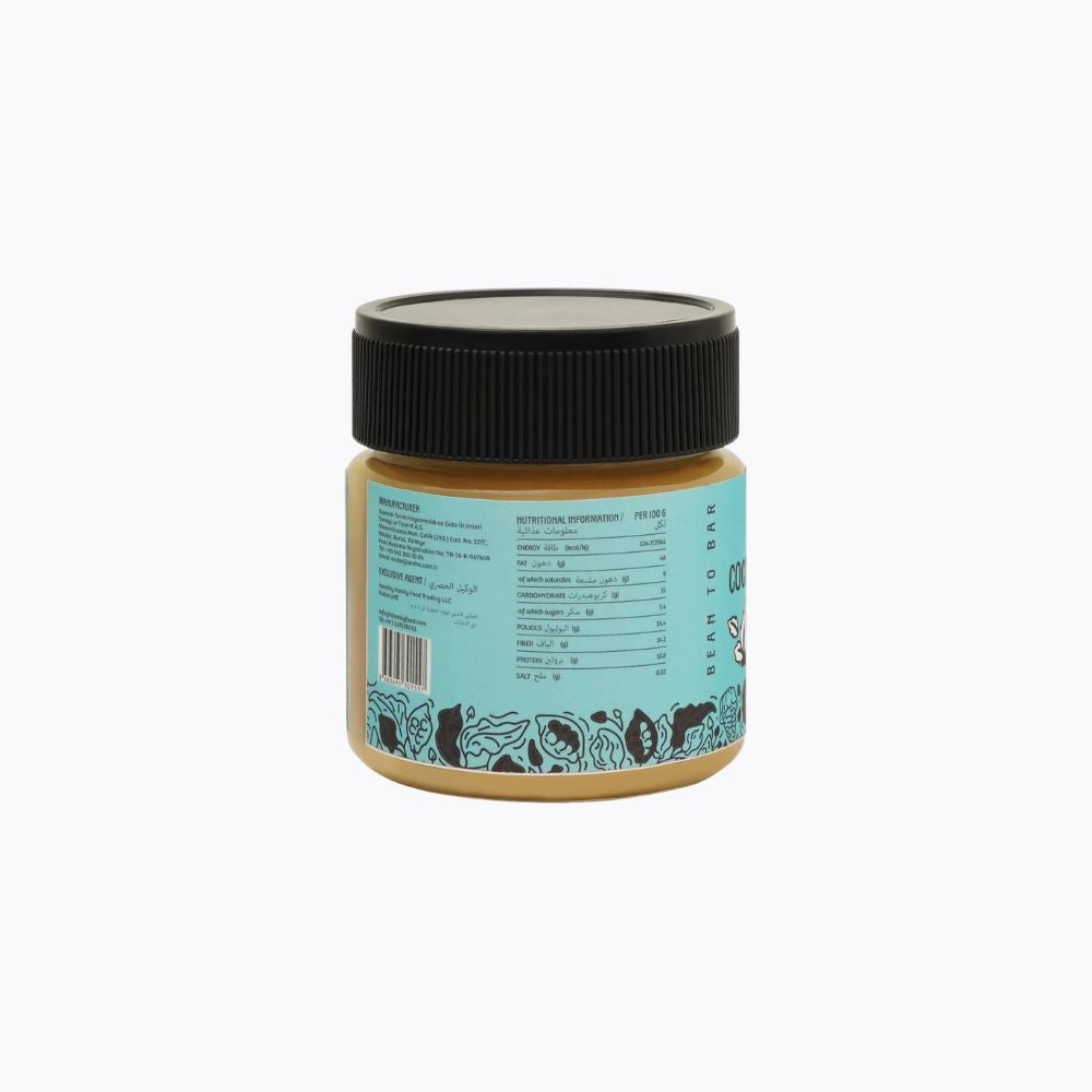 A jar of peanut butter with a black lid and a light blue label showing nutrition facts, photographed on a plain white background.