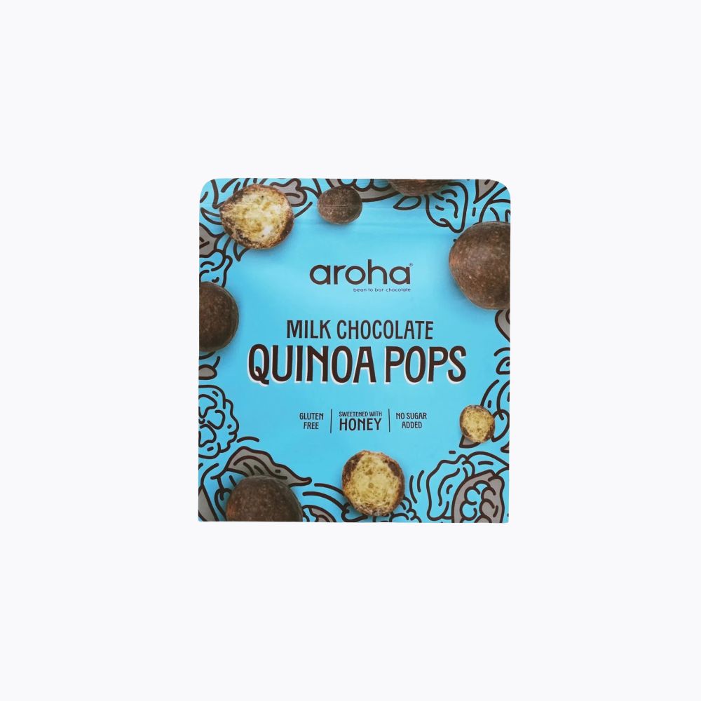 A package of Aroha Milk Chocolate Quinoa Pops on a clean white background. The packaging features a bright blue background with illustrations of chocolate-coated quinoa pops and the brand name 'aroha' printed in the center.