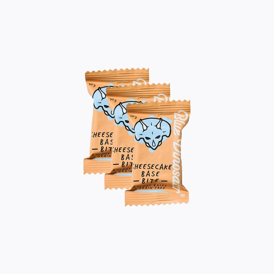 Two packages of cheesecake bites with a blue dinosaur illustration on a white background