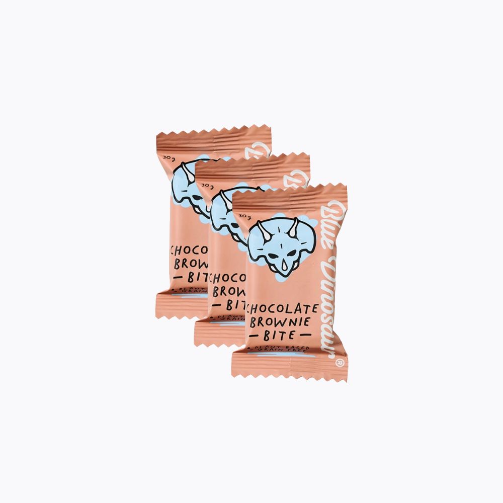 Two chocolate brownie bites in pink packaging on a white background