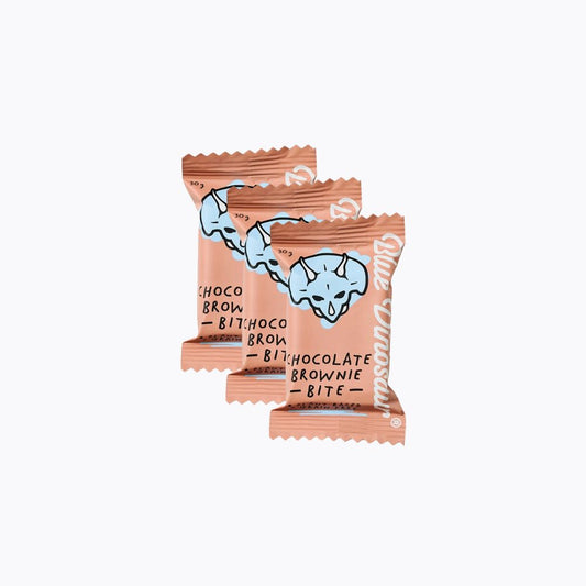 Two chocolate brownie bites in pink packaging on a white background