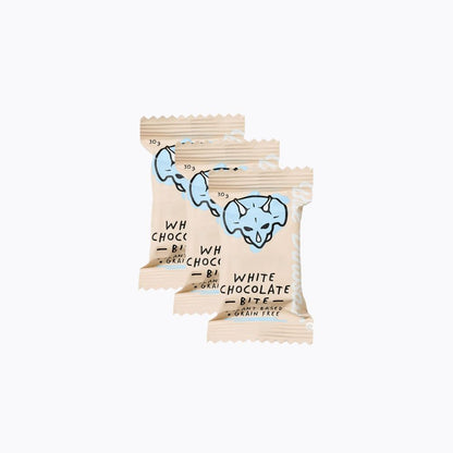 Three packages of white chocolate bites with a blue logo on a white background