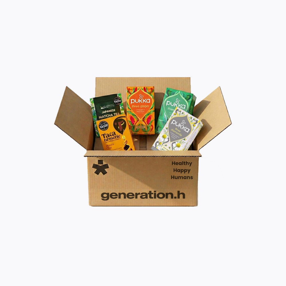 Open cardboard box with Pukka tea packages on a white background