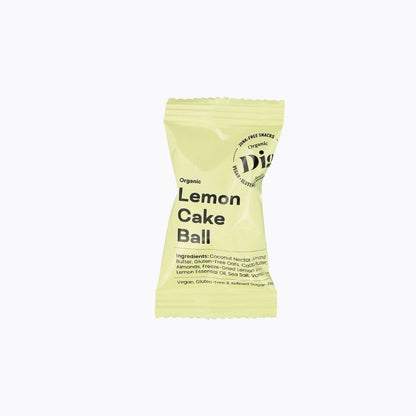 A single packaged lemon cake ball snack on a plain white background. The wrapper is pale yellow-green with black text reading 'Organic Lemon Cake Ball' and a circular logo that appears to say 'Digestive' and 'Non-GMO'.