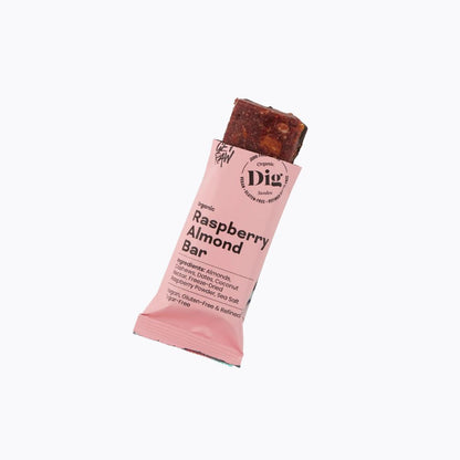 A single wrapped bar snack labeled Raspberry Almond Bar by Dig, partially unwrapped to show the dark berry and almond mixture, on a plain white background.