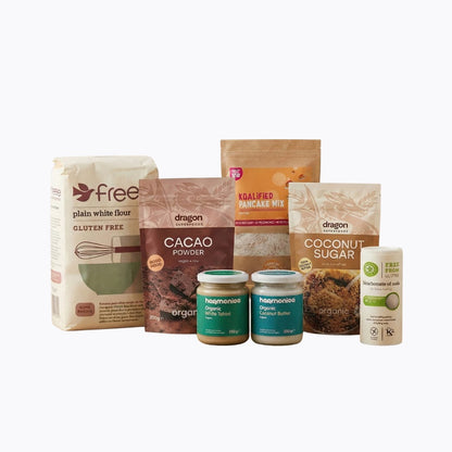 Assorted baking ingredients including flour, cacao powder, and coconut sugar on a white background