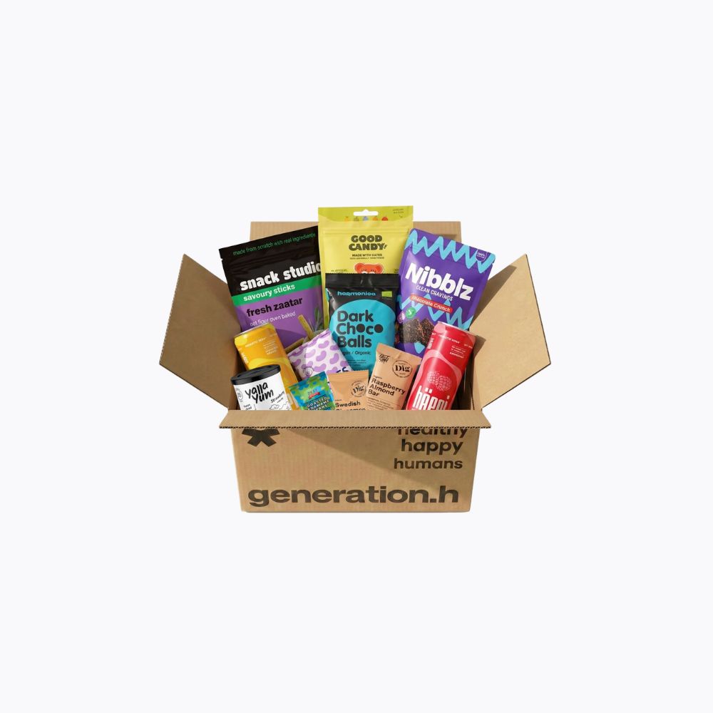 Open cardboard box filled with various snack packages on a white background, featuring the brand 'generation.h'.