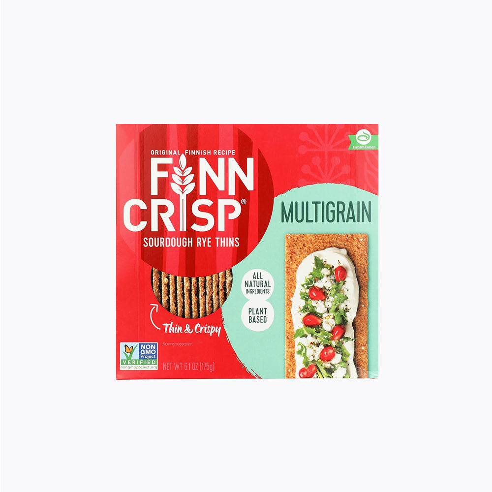 A package of Finn Crisp multigrain thin crispbread. The packaging is predominantly red with an image of the crispbread on the left and a depiction of the product being used as a sandwich base on the right.