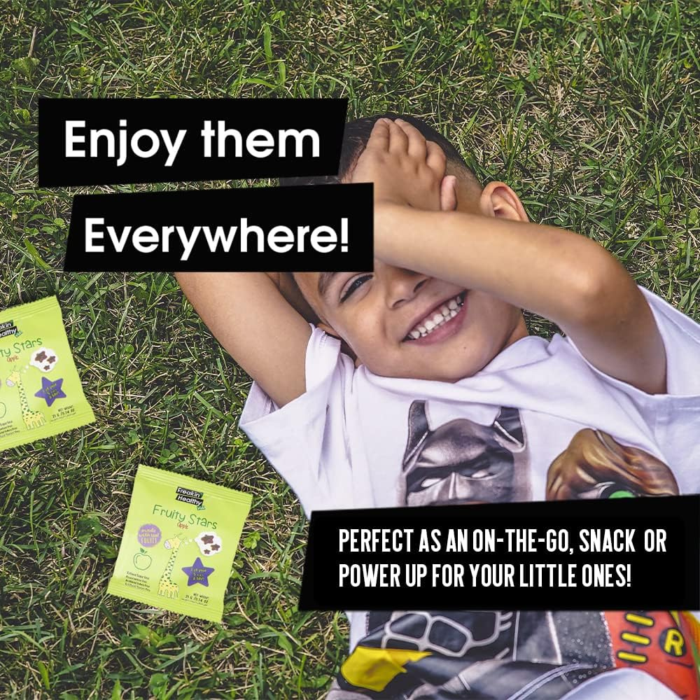 Child lying on grass with green snack packages and promotional text.