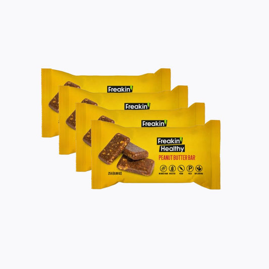 Four packages of Freakin' Healthy Peanut Butter Bars on a white background