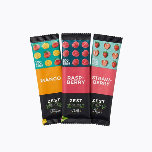 Three Zest Delites fruit leather sticks in mango, raspberry, and strawberry flavors on a white background.