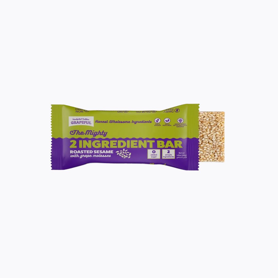 2 Ingredient Bar with roasted sesame and grape molasses on a white background