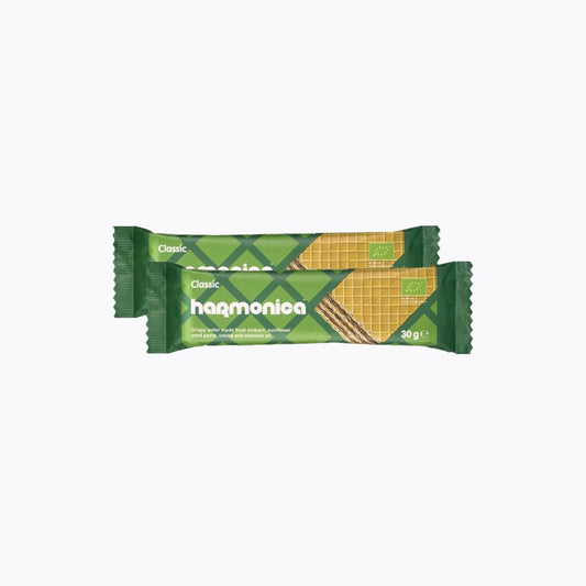 Green and yellow package of harmonica classic wafers on a white background
