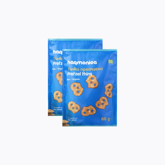 Two packages of haq organic pretzel thins on a white background