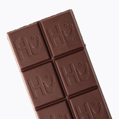 Chocolate bar with embossed 'HU' logo on a white background