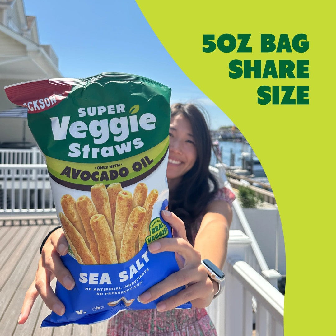 Person holding a bag of Super Veggie Straws with a scenic background