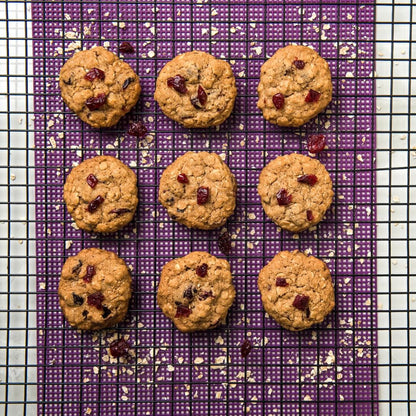 Cookies with raisins on a purple cooling rack