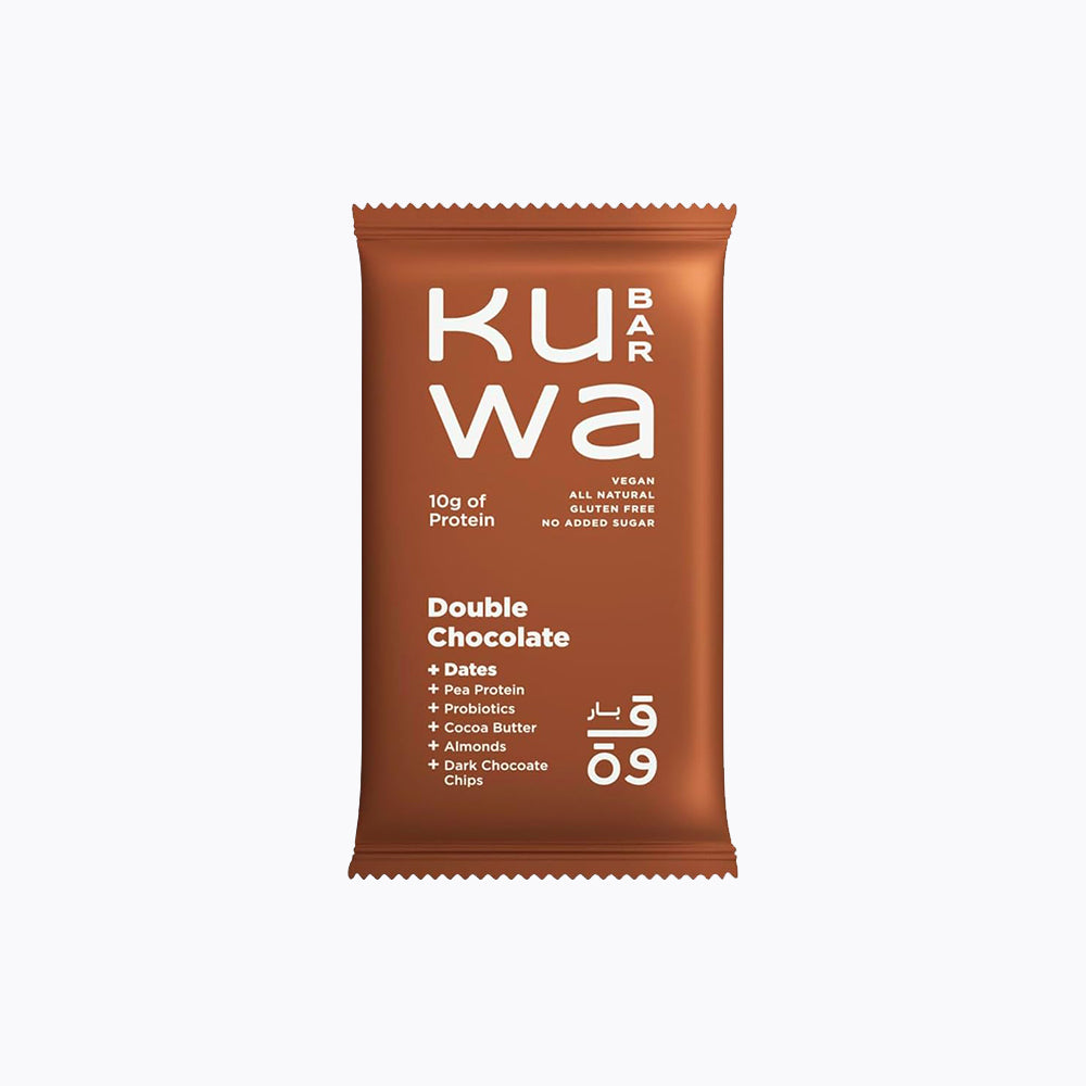 A packaged food item labeled 'KUWA Double Chocolate' with various dietary descriptions such as 'all natural', 'gluten free', 'source of protein', 'high protein', 'vegan', 'no added sugar', and 'no refined sugar'. The package is brown with white and orange text.