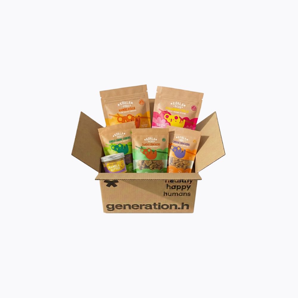 A cardboard gift box filled with assorted pet treats and pouches from Generation H, photographed on a clean white background.