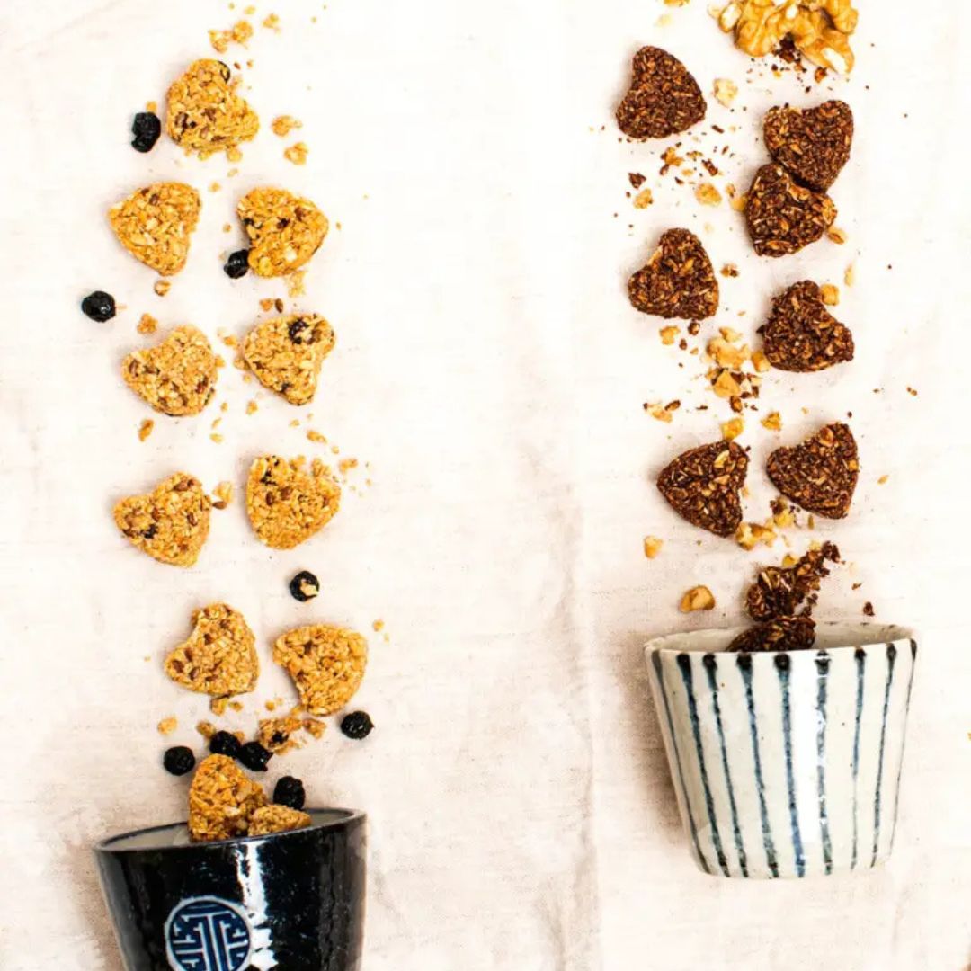 Heart-shaped cookies in two cups on a white background