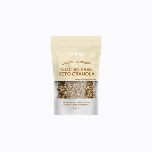 A 30g stand-up pouch of Naturiga Gluten Free Keto Granola, featuring a cream-colored top half, brown text, and a clear window showing the granola inside, set against a plain white background.