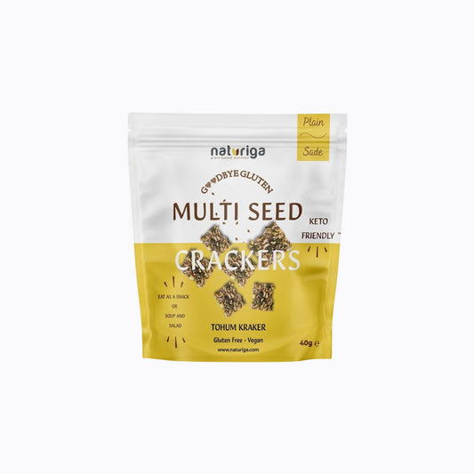 A 30g stand-up pouch of Naturiga Gluten Free Keto Granola, featuring a cream-colored top half, brown text, and a clear window showing the granola inside, set against a plain white background.