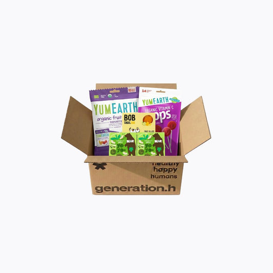 Open cardboard box containing YumEarth candy packages on a white background