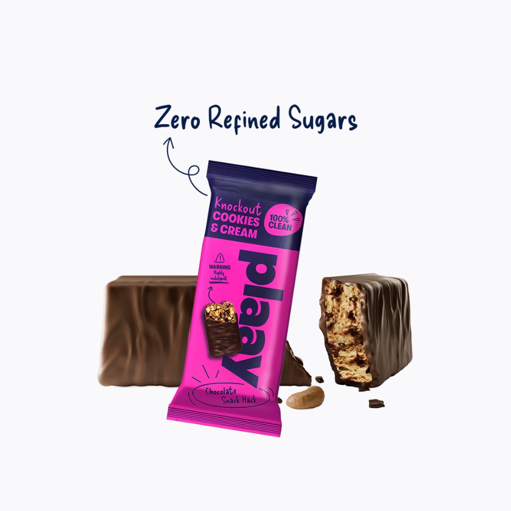 Pink protein bar packaging with chocolate pieces on a white background