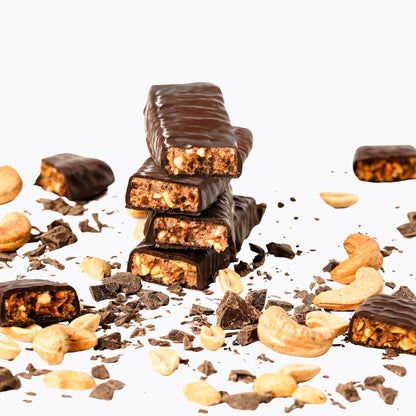 Stack of chocolate-covered candy bars with nuts on a white background