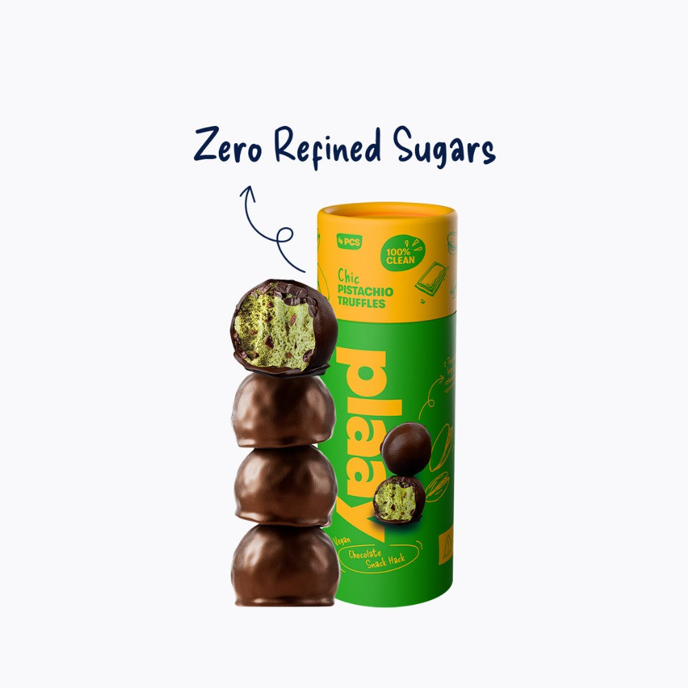 Green and yellow packaging of chocolate-covered pistachios with a stack of chocolates on a white background.