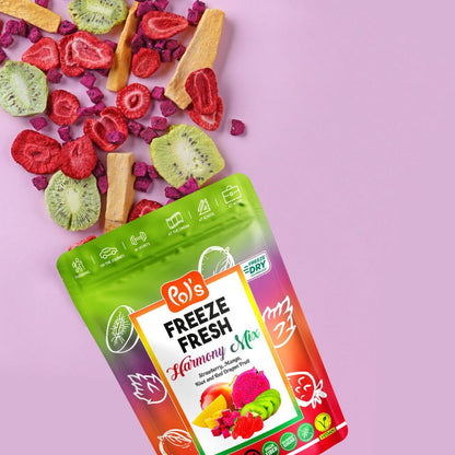 A stand-up pouch of Bo's Freeze Fresh Harmony Mix dried fruit snack mix, shown on a light pink background with pieces of the mixed dried fruit spilled out above the package.