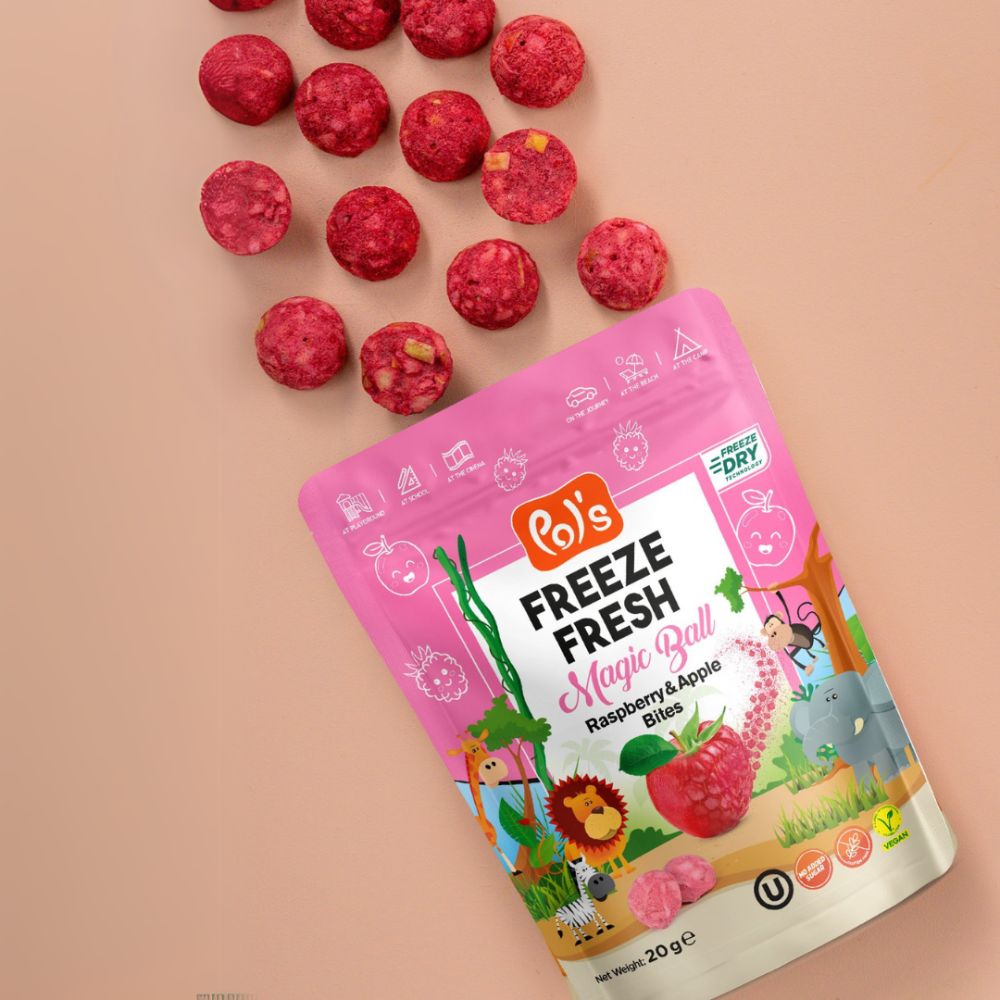 A pink stand-up pouch of Ro's Freeze Fresh Magic Ball Raspberry & Apple Blister balls, shown on a peach background with several pink balls scattered above it.
