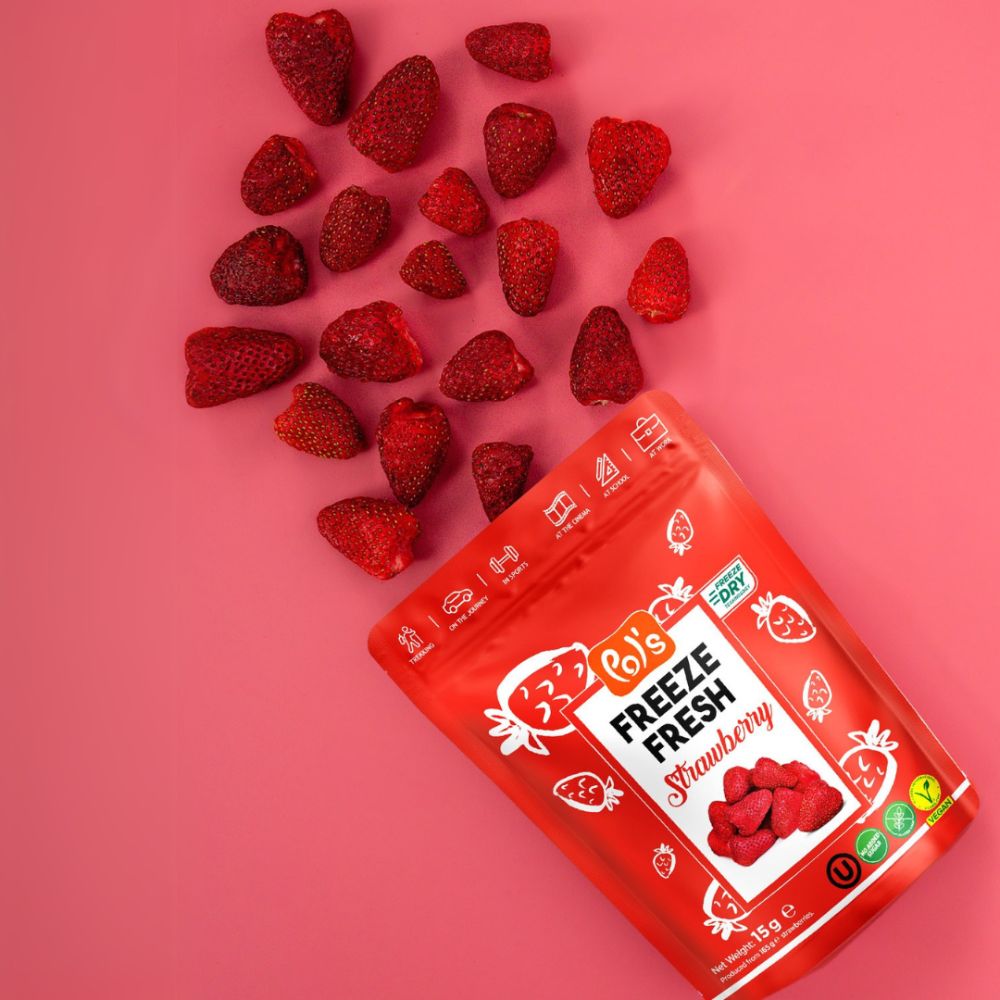 Red freeze-dried strawberry package with strawberries on a pink background