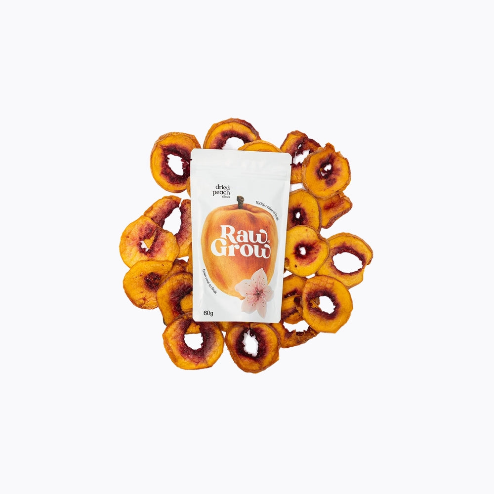 Dried peaches arranged around a Raw Grow packaging on a white background