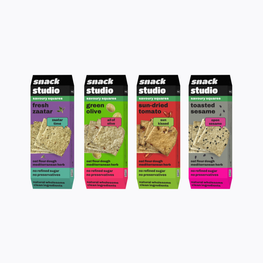 Four packages of snack studio savory squares on a white background