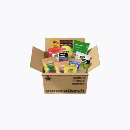 Open cardboard box with snacks and 'healthy happy humans' branding on a white background