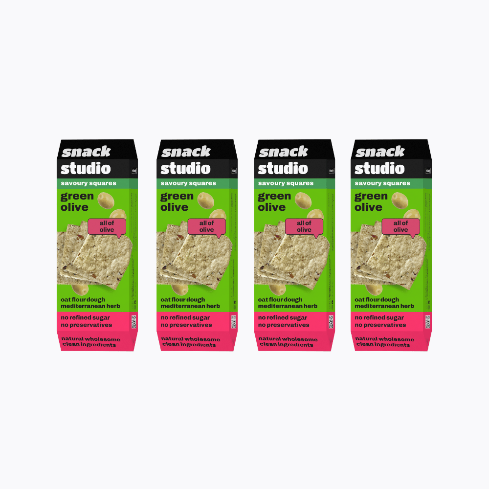 Multiple packages of Snack Studio green olive snack squares on a white background