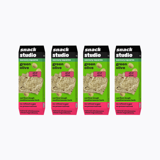 Multiple packages of Snack Studio green olive snack squares on a white background
