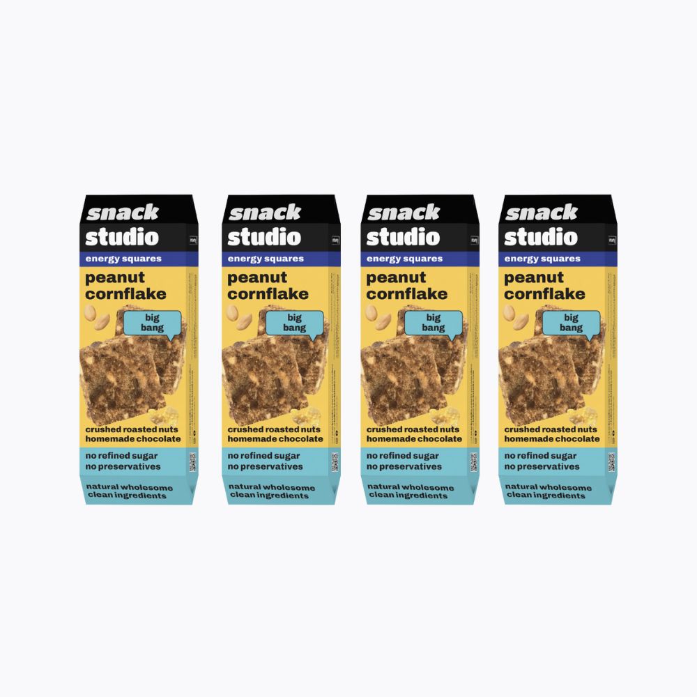 Four packages of snack studio peanut cornflake energy squares on a white background