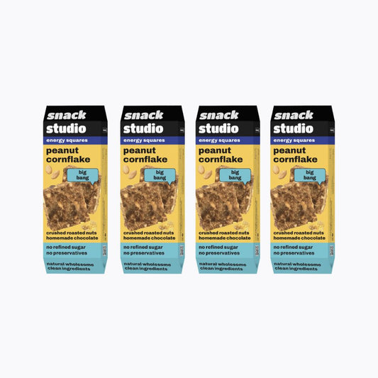 Four packages of snack studio peanut cornflake energy squares on a white background