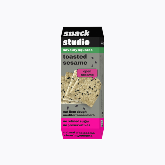Box of snack studio toasted sesame savoury squares on a white background