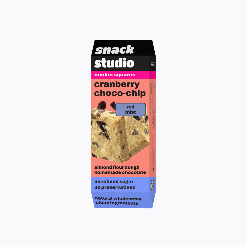 Box of Snack Studio cranberry choco-chip cookie squares on a white background