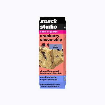 Box of Snack Studio cranberry choco-chip cookie squares on a white background