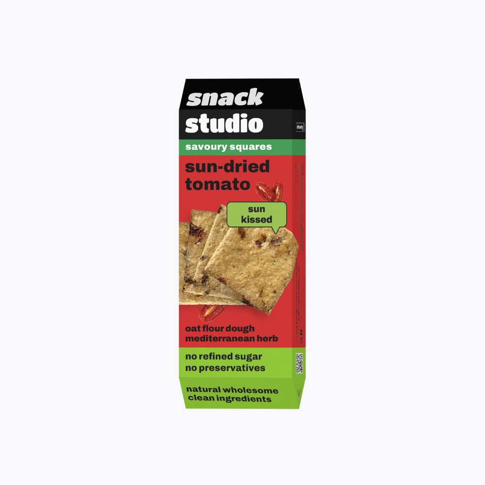 Box of snack studio sun-dried tomato savoury squares on a white background