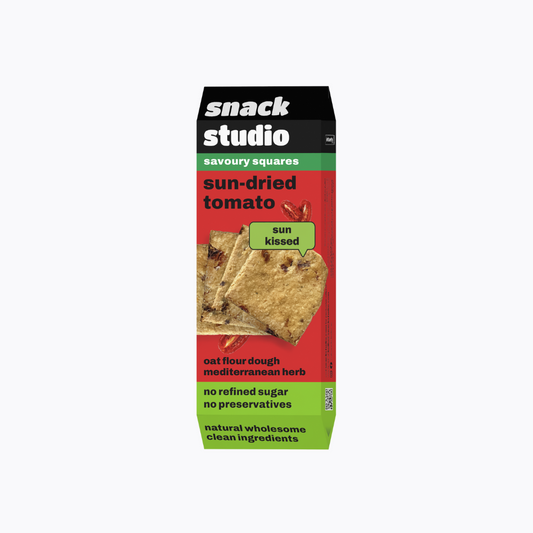 Box of snack studio sun-dried tomato savoury squares on a white background