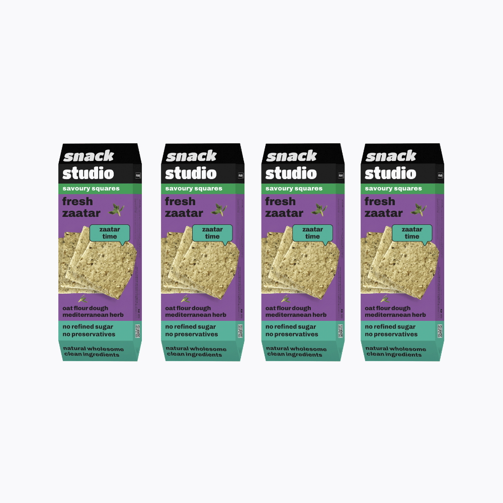 Multiple packages of snack studio fresh zaatar savory squares on a white background