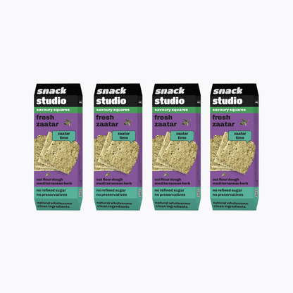 Multiple packages of snack studio fresh zaatar savory squares on a white background