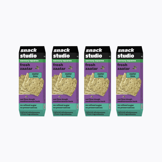 Multiple packages of snack studio fresh zaatar savory squares on a white background